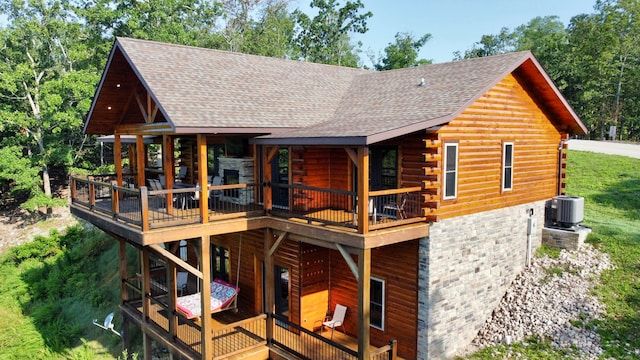 rear view of house with a deck and central AC