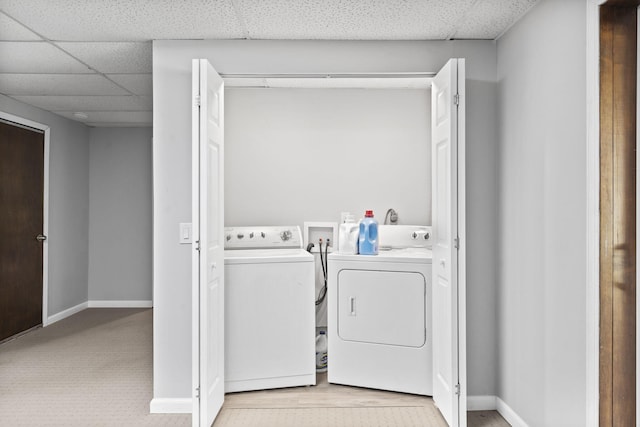 washroom featuring laundry area, independent washer and dryer, and baseboards