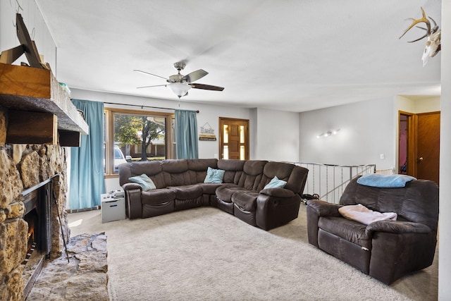 carpeted living area featuring a ceiling fan and a fireplace