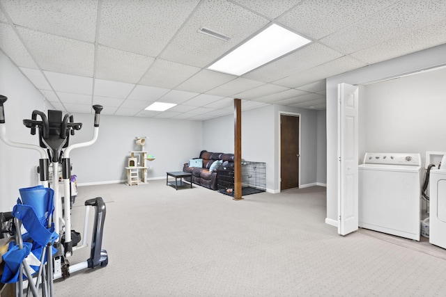 workout room with baseboards, visible vents, washer and clothes dryer, and a drop ceiling