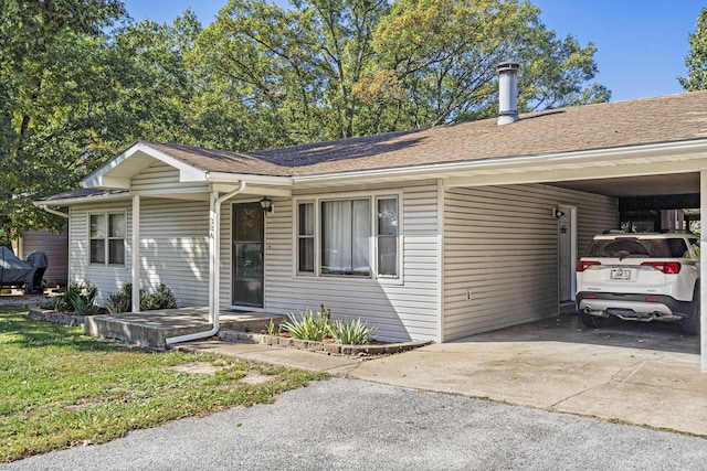 single story home featuring an attached carport, roof with shingles, and driveway