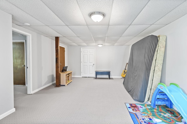 game room with a paneled ceiling, carpet flooring, and baseboards