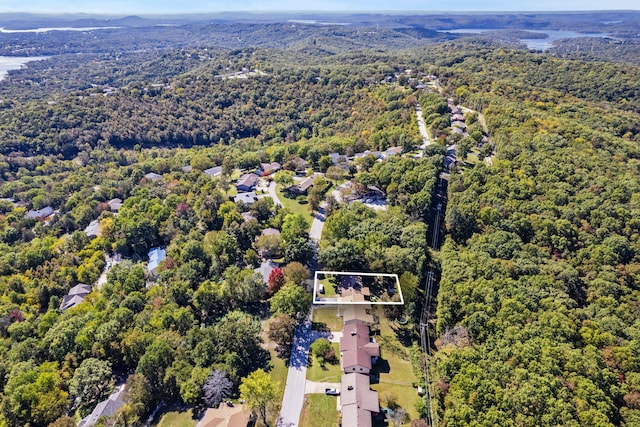 birds eye view of property featuring a wooded view