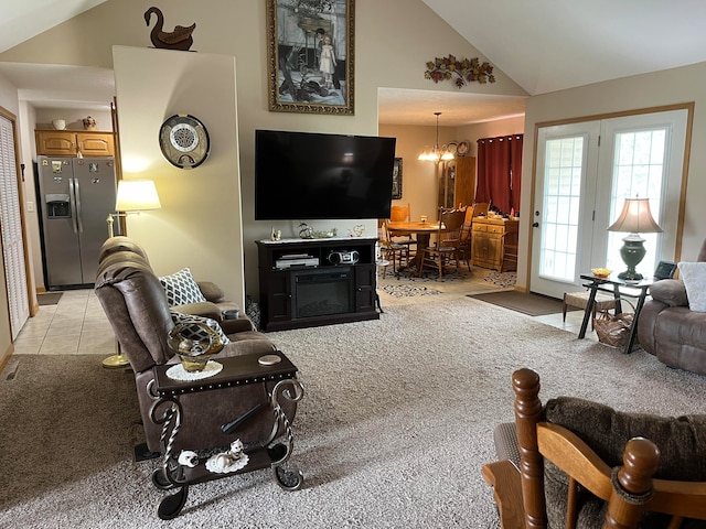 carpeted living room with high vaulted ceiling and a notable chandelier