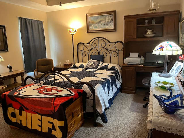 bedroom with dark colored carpet