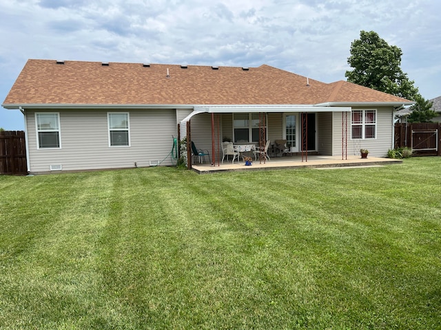 back of property featuring a yard and a patio