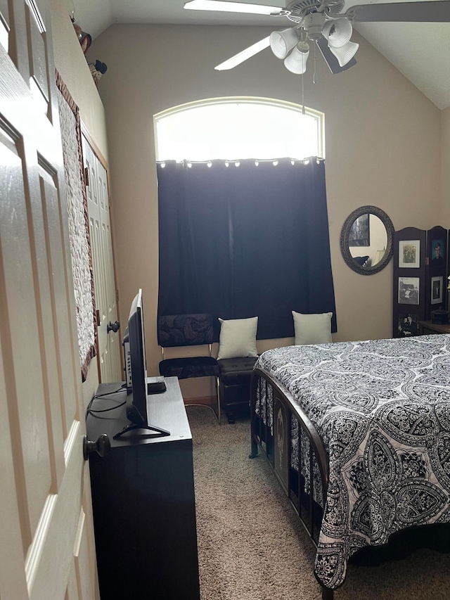 carpeted bedroom featuring lofted ceiling, multiple windows, ceiling fan, and a closet