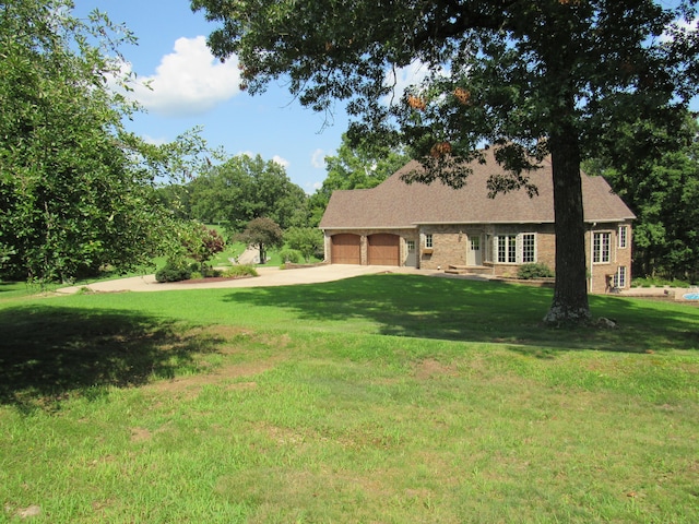 view of front of home with a garage and a front lawn