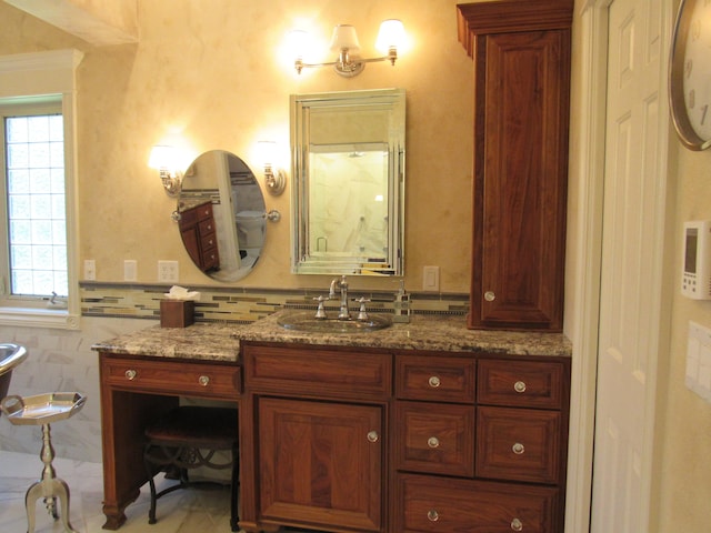 bathroom with vanity and tile walls