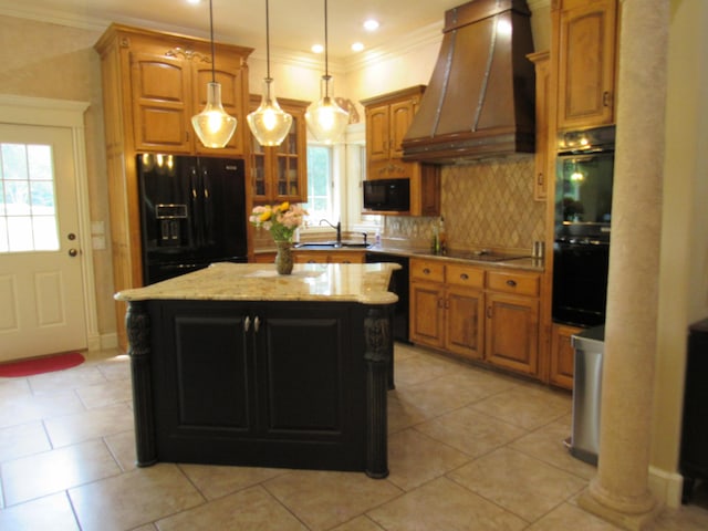 kitchen featuring pendant lighting, a kitchen island, custom exhaust hood, black appliances, and light tile patterned floors