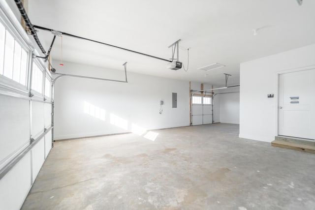 garage with electric panel and a garage door opener