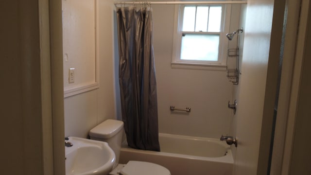 full bathroom with sink, shower / bath combo with shower curtain, and toilet