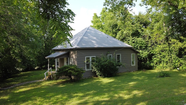 view of side of home with a lawn