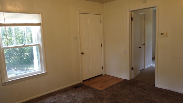 interior space featuring dark colored carpet