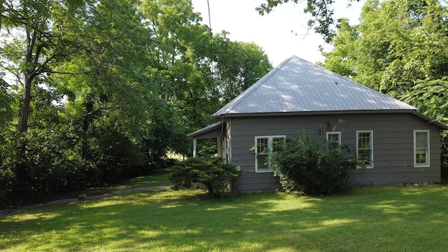 view of side of home with a yard