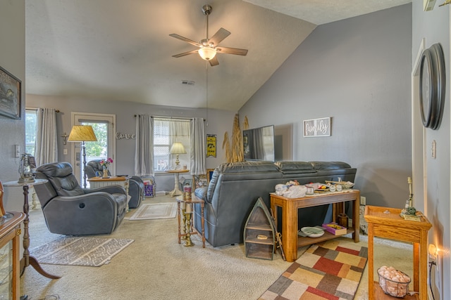 living room with a textured ceiling, vaulted ceiling, carpet flooring, and ceiling fan