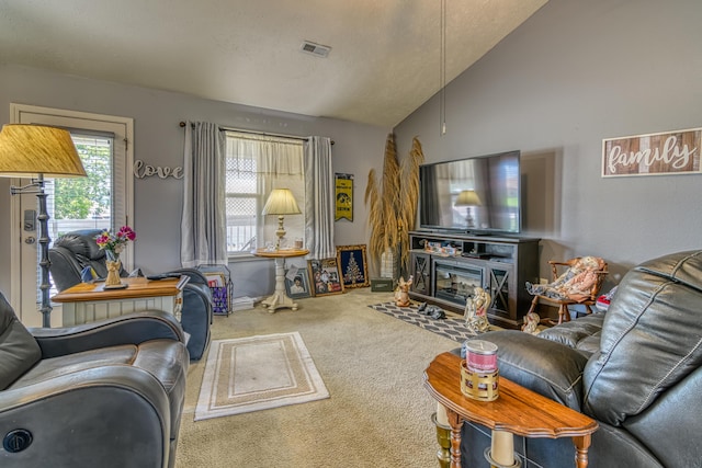 living room with lofted ceiling, carpet flooring, and visible vents
