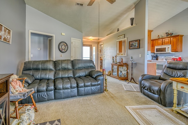living room featuring light colored carpet, a ceiling fan, visible vents, and high vaulted ceiling