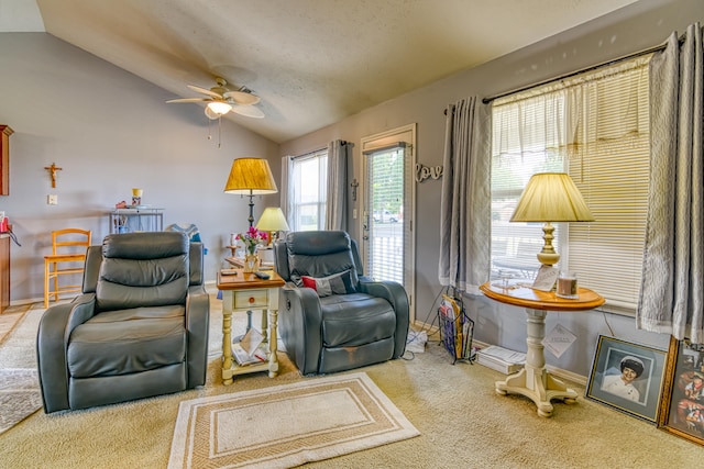 sitting room with ceiling fan, a textured ceiling, vaulted ceiling, and carpet