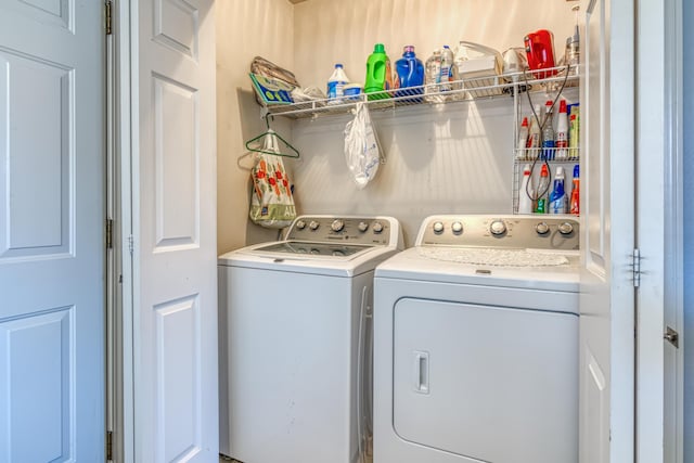 washroom with separate washer and dryer and laundry area