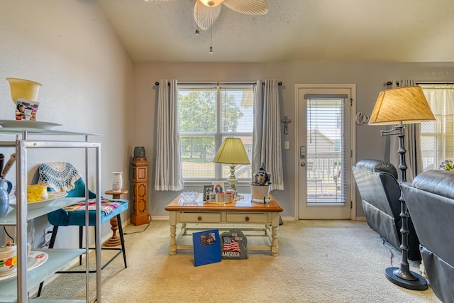carpeted office with baseboards and a ceiling fan