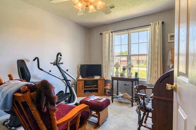 office featuring ceiling fan, light colored carpet, and a textured ceiling