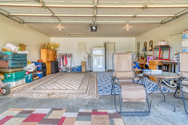 garage featuring a garage door opener and white fridge