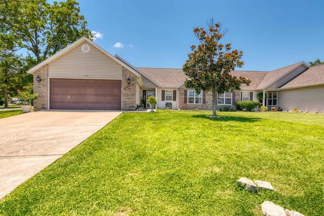 single story home with roof with shingles, concrete driveway, brick siding, a garage, and a front yard