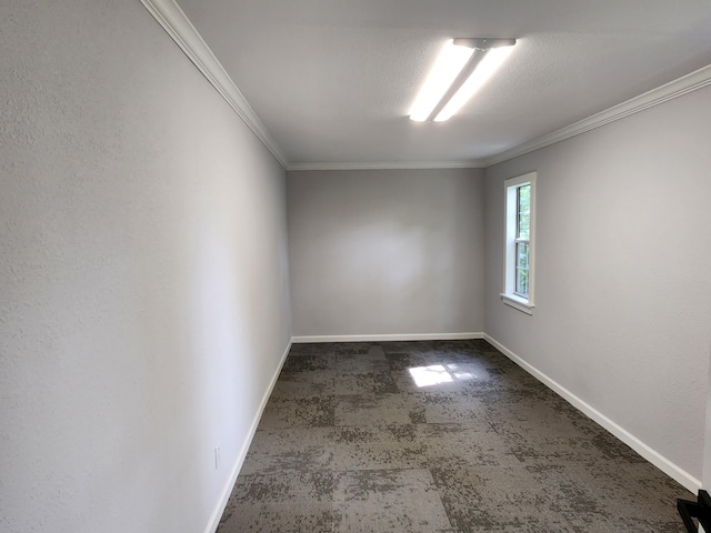 empty room with a textured ceiling and crown molding