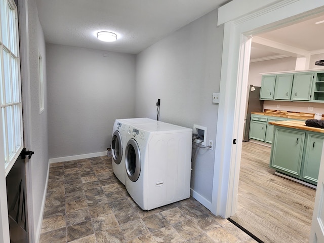 washroom with a textured ceiling and washer and clothes dryer