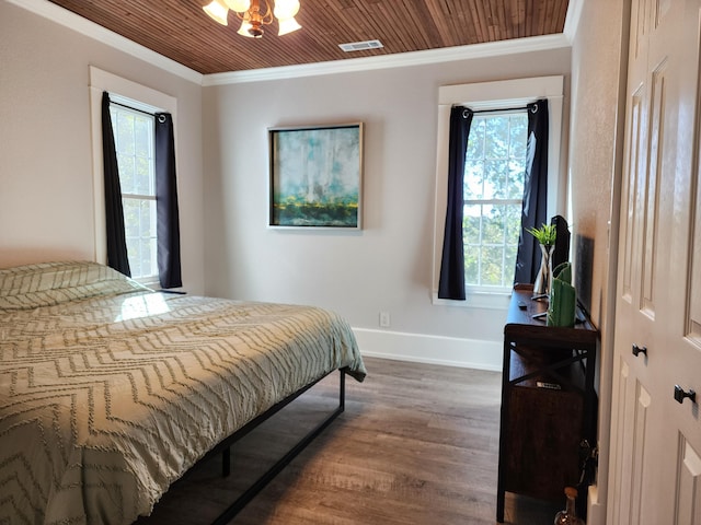 bedroom with hardwood / wood-style flooring, an inviting chandelier, ornamental molding, and wooden ceiling