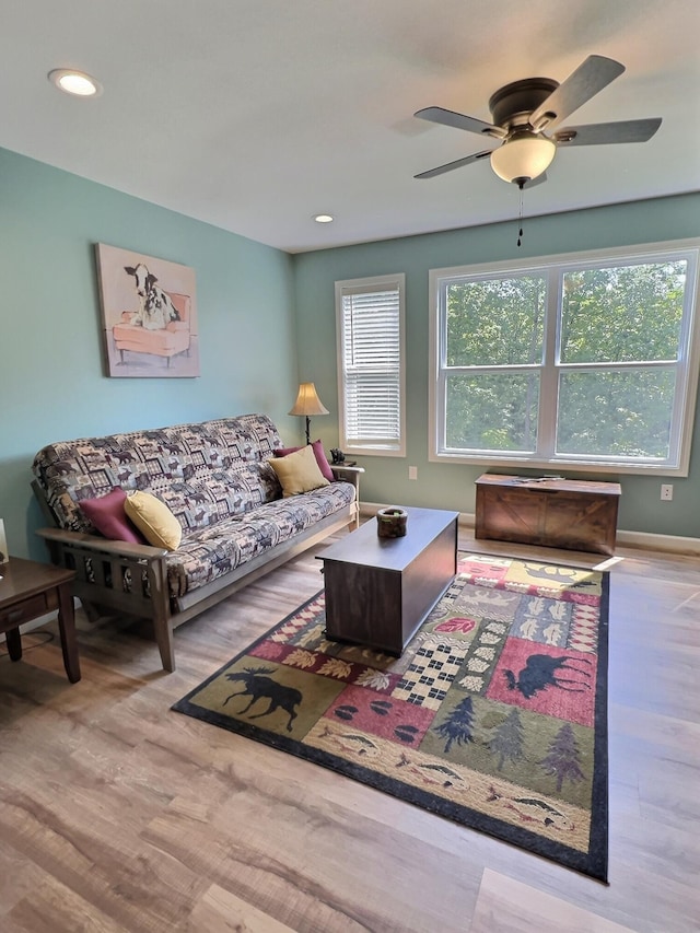 living room featuring ceiling fan and light hardwood / wood-style flooring