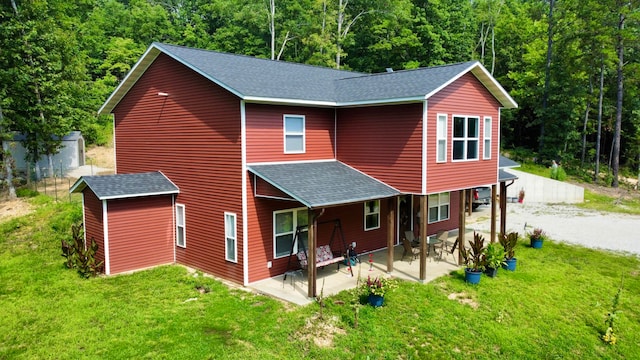 rear view of property featuring a yard