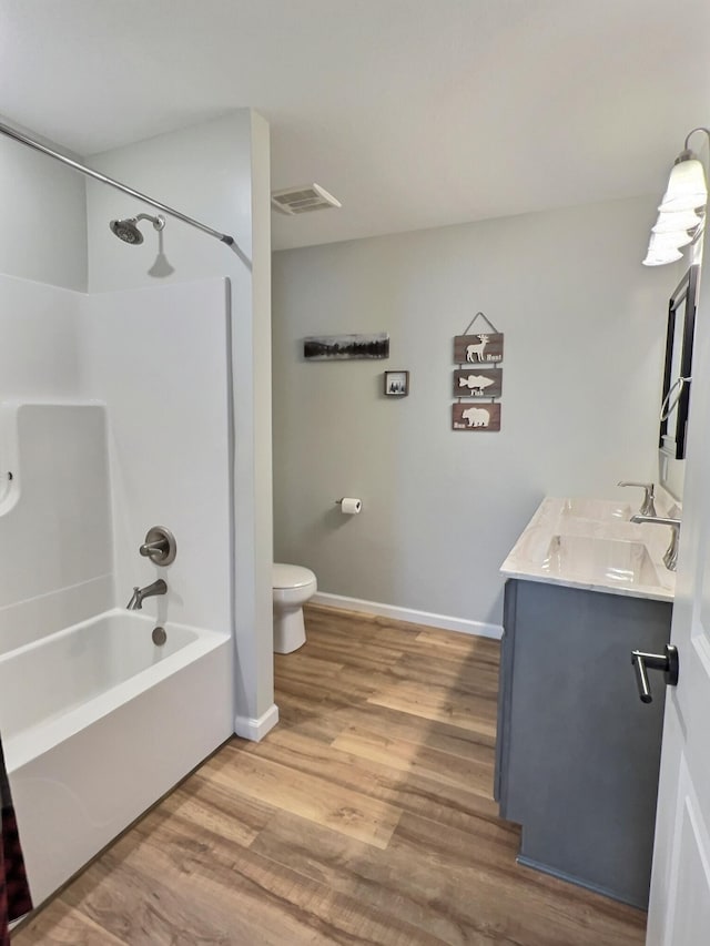 full bathroom featuring shower / bathing tub combination, vanity, toilet, and hardwood / wood-style flooring