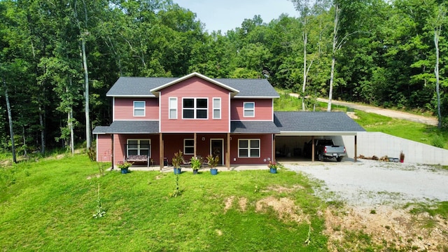 view of front of property with a porch, a carport, and a front lawn