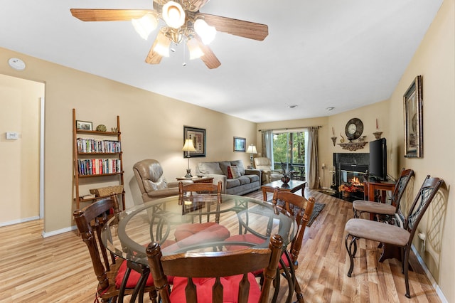 dining room with light hardwood / wood-style flooring and ceiling fan