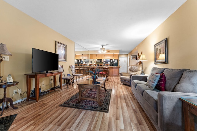 living room featuring hardwood / wood-style flooring and ceiling fan