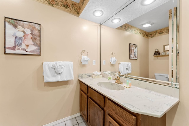 bathroom featuring a textured ceiling, tile patterned floors, vanity, and toilet