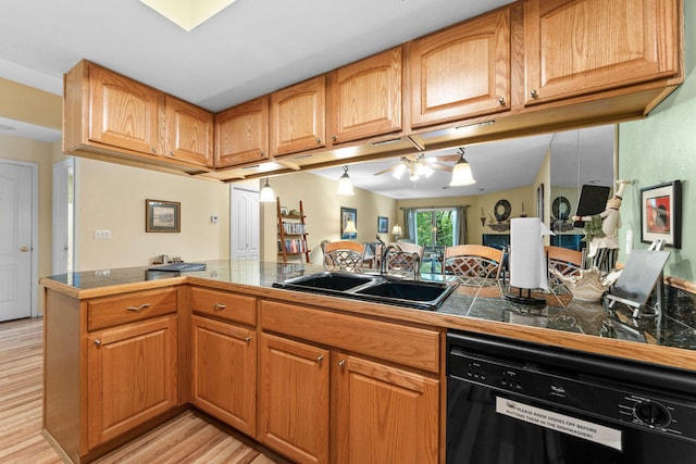 kitchen with kitchen peninsula, sink, light hardwood / wood-style flooring, and dishwasher