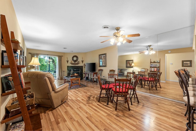 dining area featuring ceiling fan and light hardwood / wood-style floors