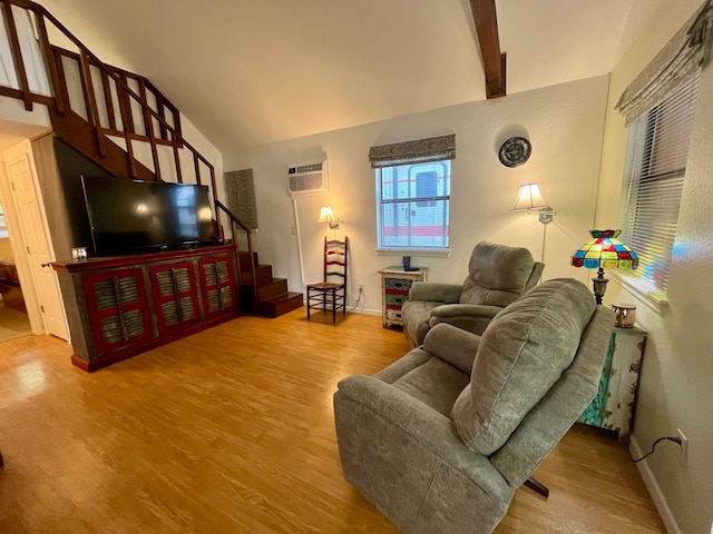 living room with hardwood / wood-style flooring, beamed ceiling, high vaulted ceiling, and a wall mounted air conditioner