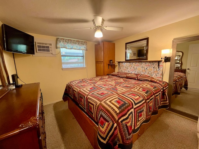 bedroom with ceiling fan, dark colored carpet, and a wall unit AC