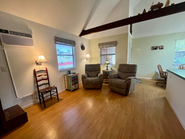 living room featuring an AC wall unit, plenty of natural light, vaulted ceiling with beams, and hardwood / wood-style floors