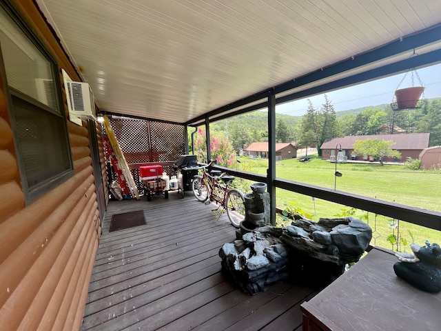 wooden terrace with a lawn