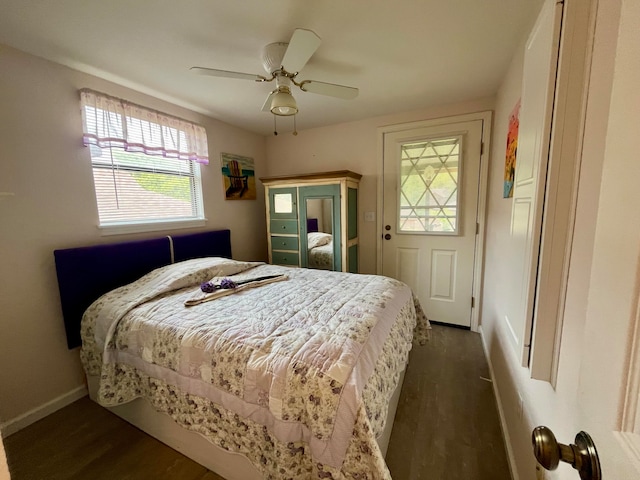 bedroom with dark hardwood / wood-style floors and ceiling fan