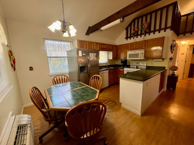 kitchen with pendant lighting, white appliances, dark hardwood / wood-style flooring, a notable chandelier, and vaulted ceiling with beams