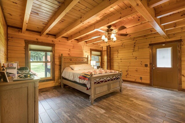 bedroom with wood walls, beamed ceiling, wooden ceiling, and light wood-style floors