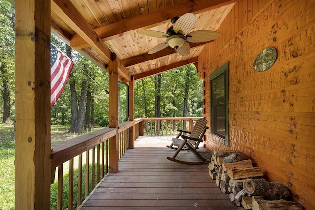 wooden terrace with a porch and a ceiling fan