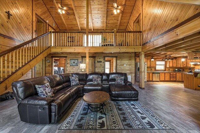 living room featuring wood ceiling, ceiling fan, wooden walls, and wood finished floors