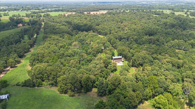 drone / aerial view with a wooded view